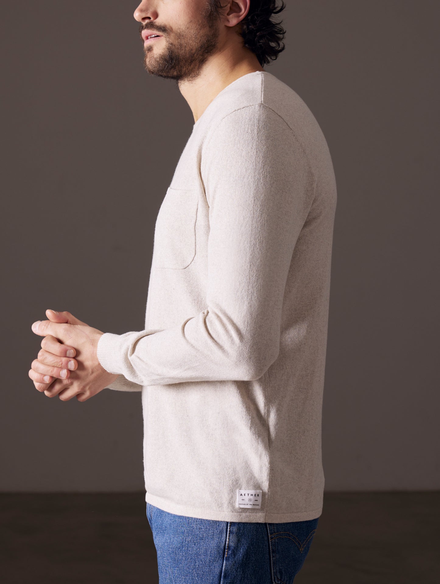 Man wearing light tan sweater from AETHER Apparel