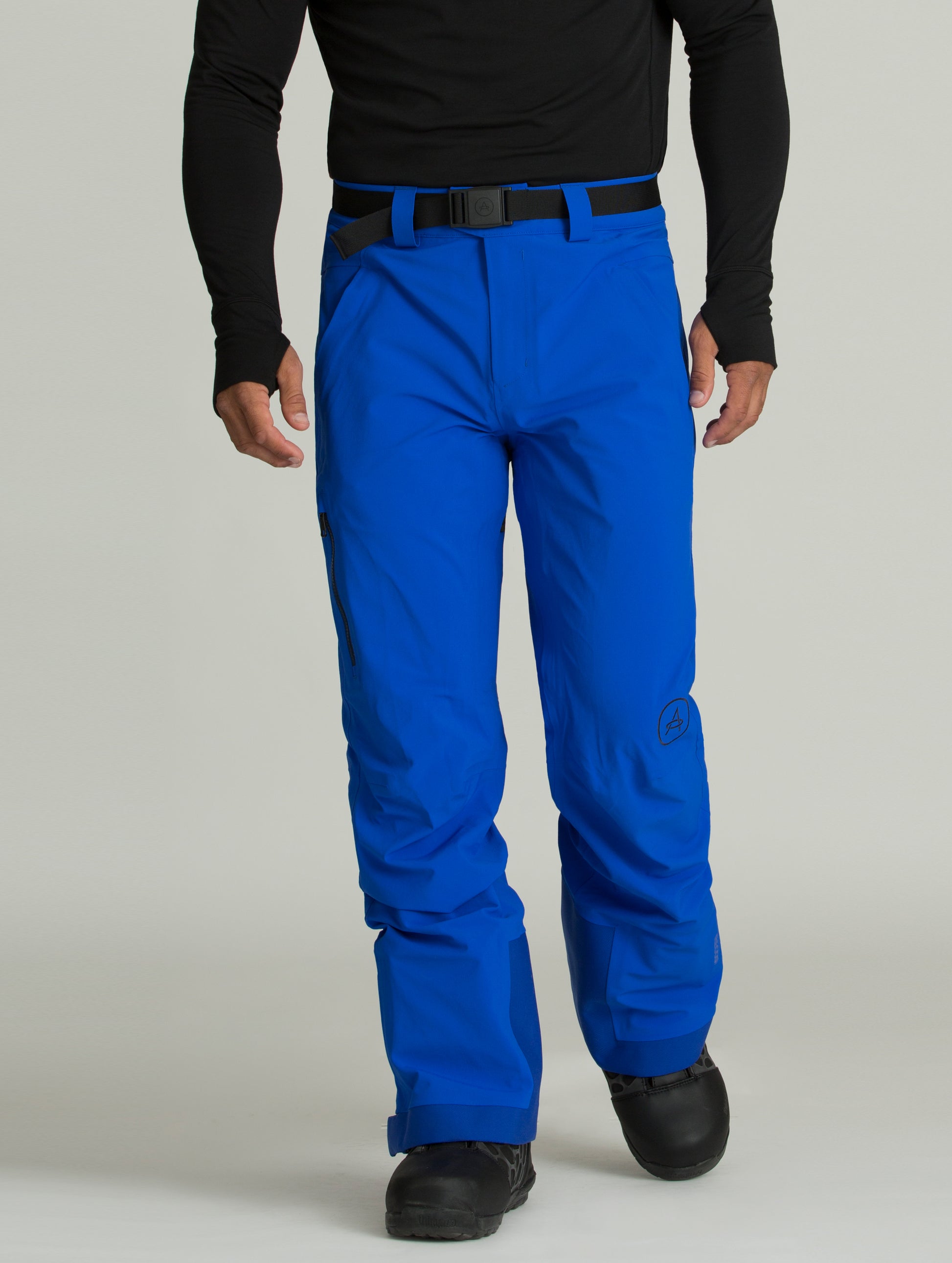Man wearing a blue Approach Snow Pant from AETHER Apparel.