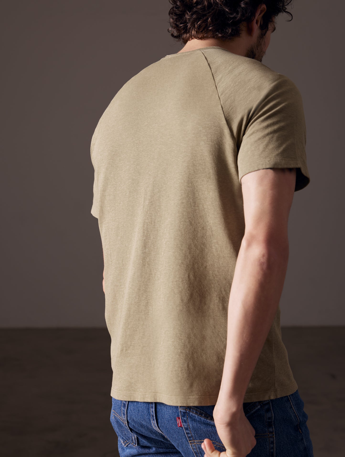 back view of man wearing green cotton tee