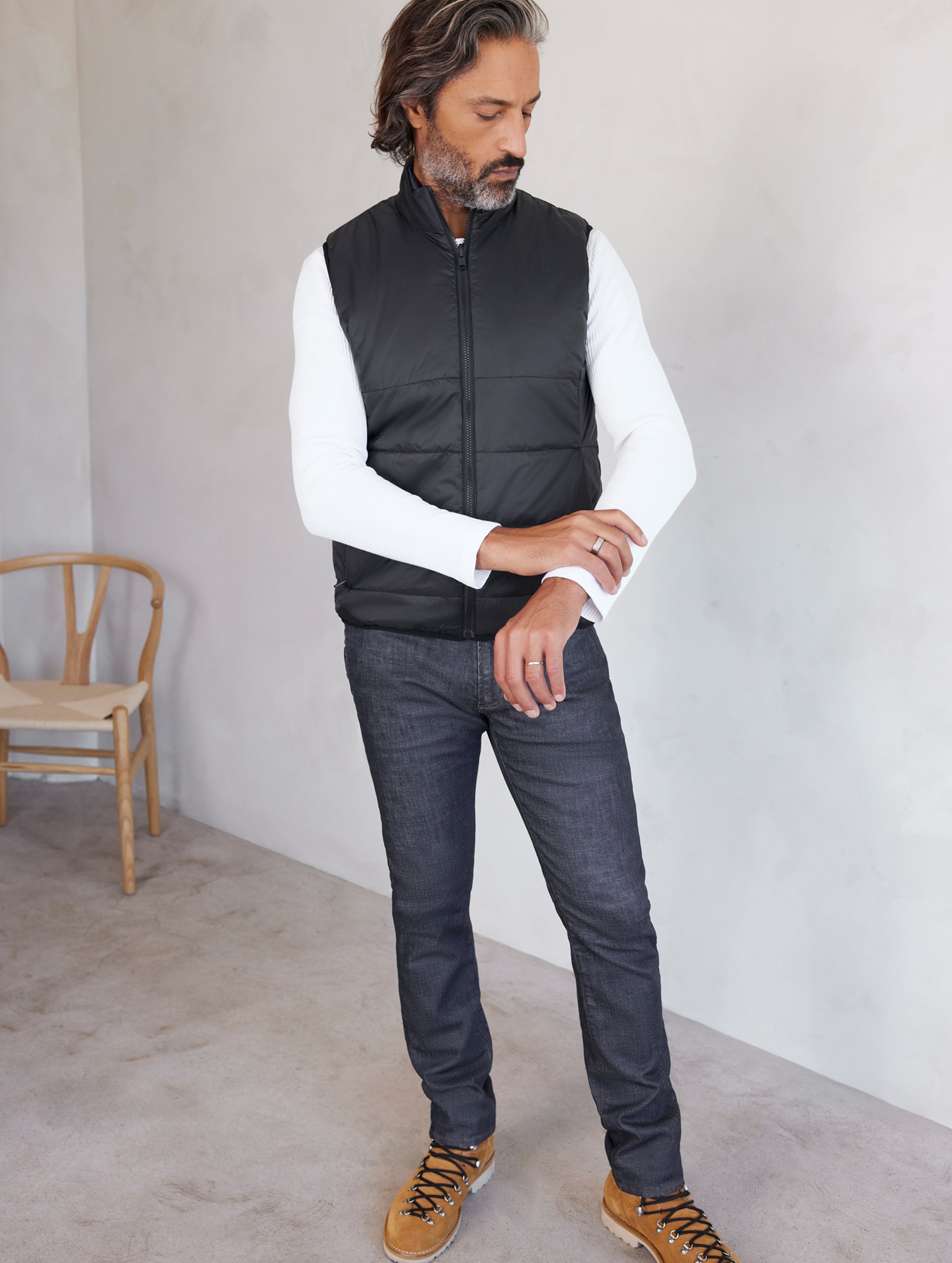 man wearing black side of reversible insulated vest