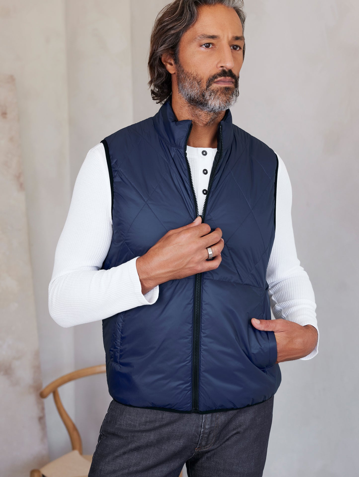 man wearing blue side of reversible insulated vest