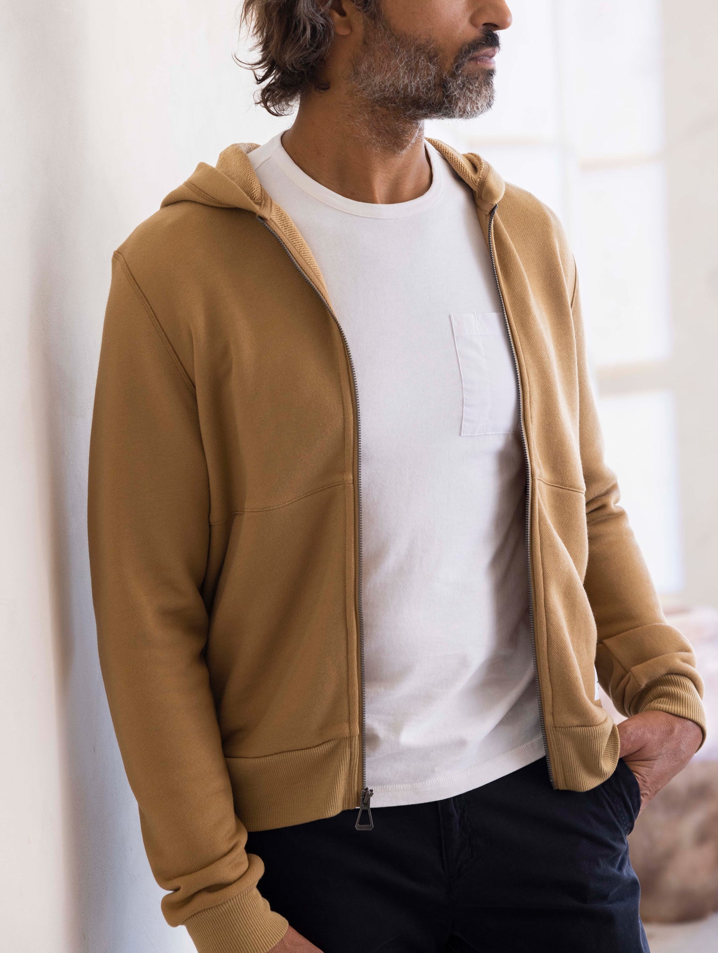 man wearing a brown full zip hoodie
