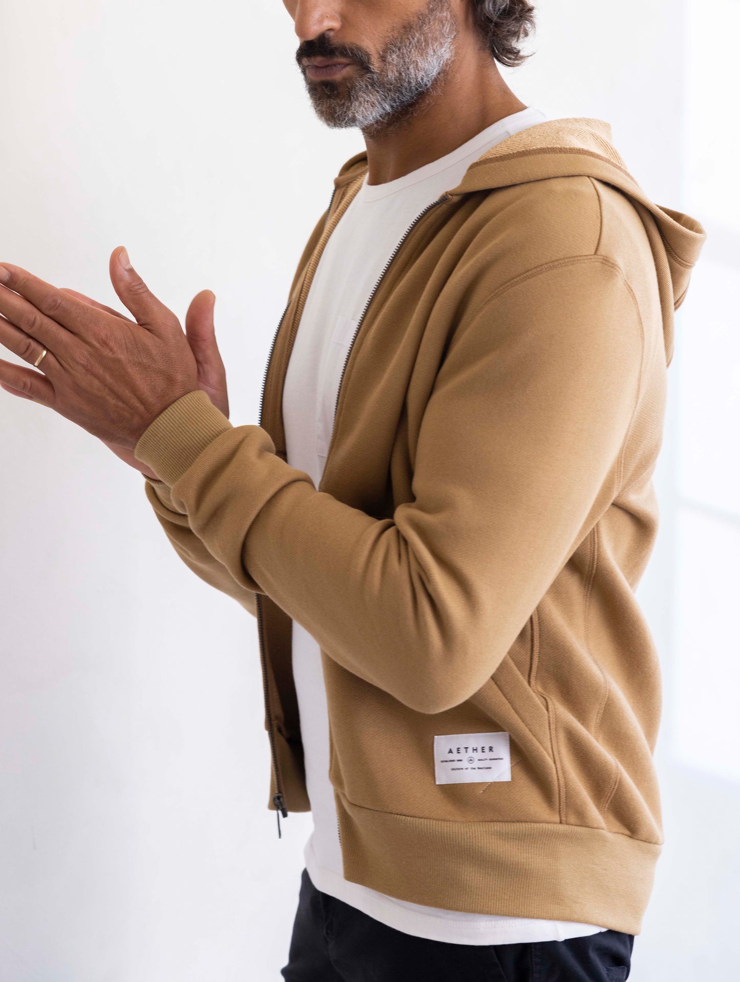 man wearing a brown full zip hoodie