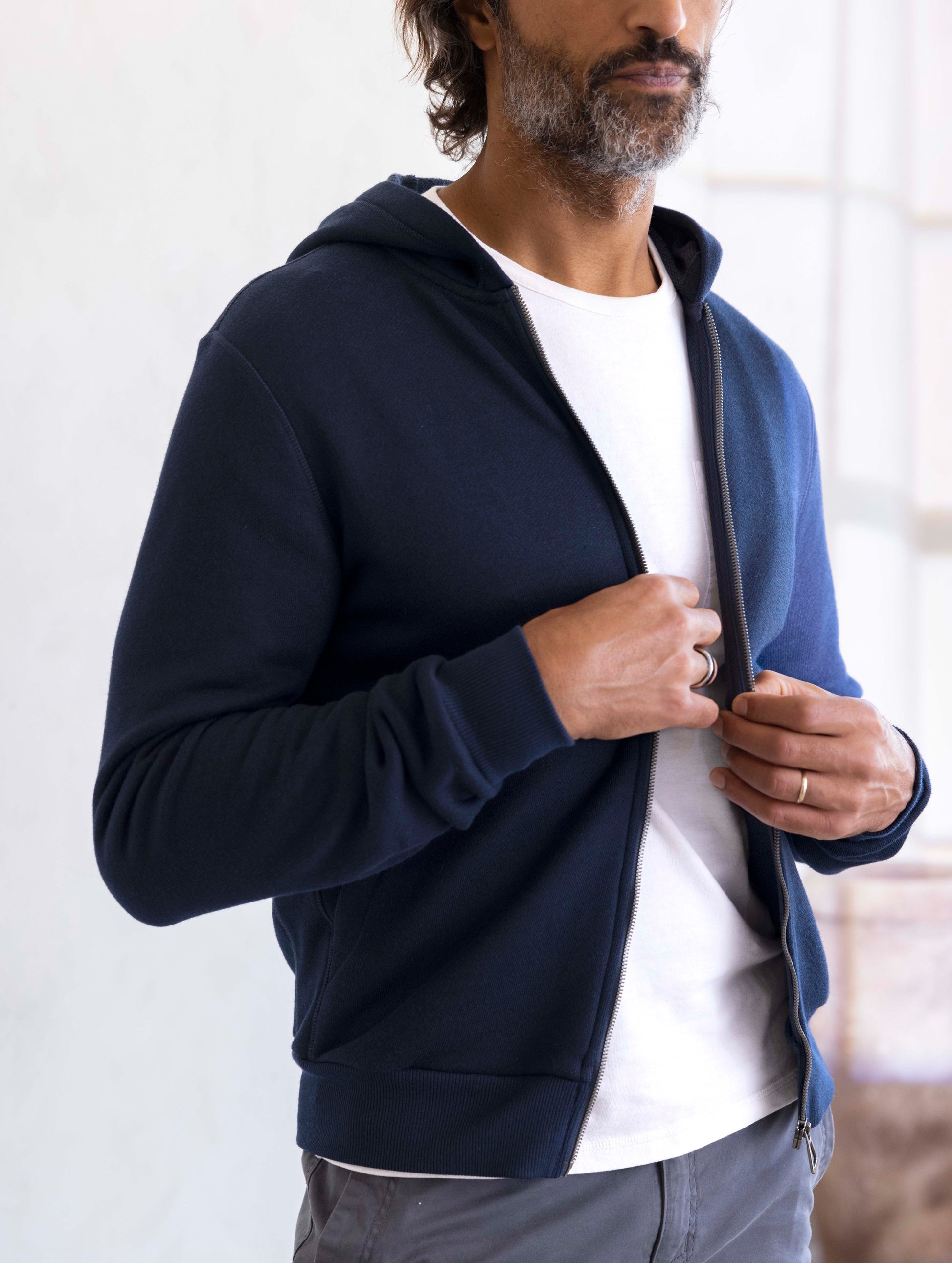 man wearing a navy full zip hoodie