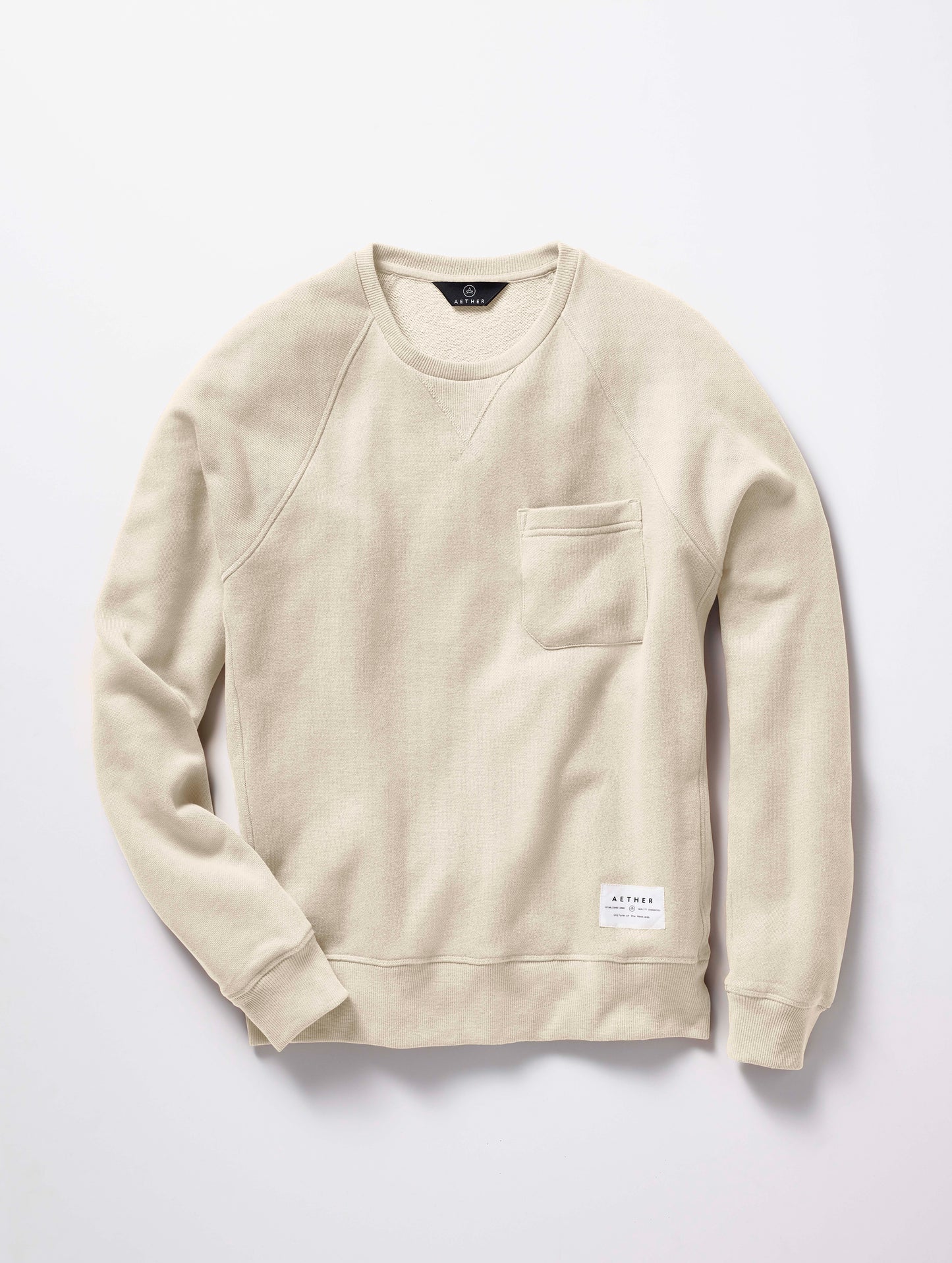 man wearing a beige crew neck with pocket