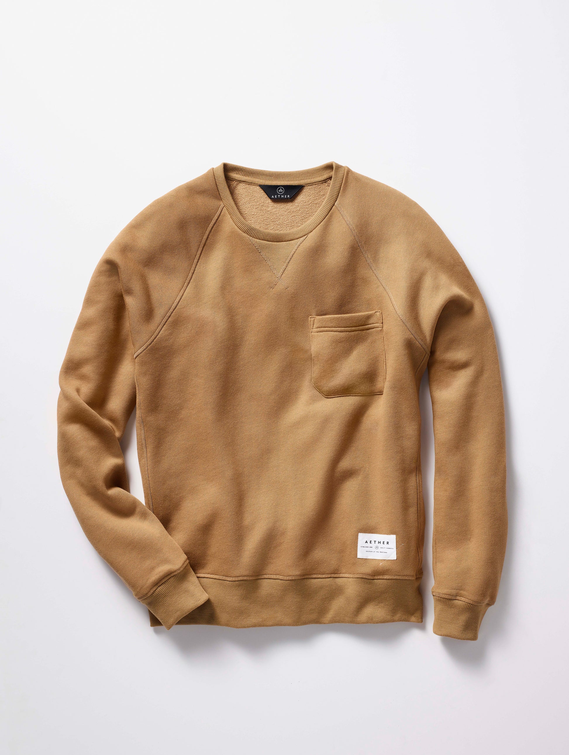 man wearing a brown crew neck with pocket