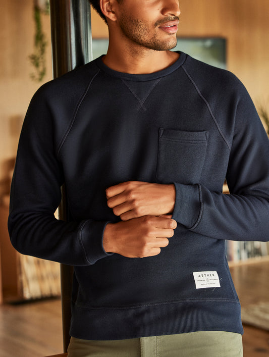 man wearing a navy crew neck with pocket