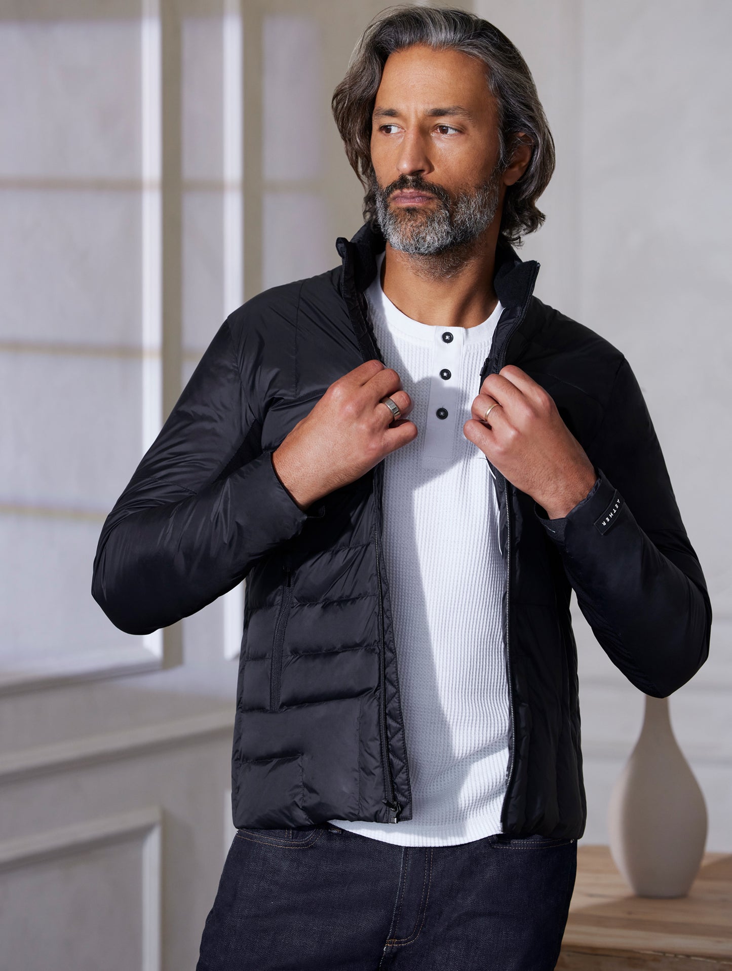 man wearing quilted black jacket