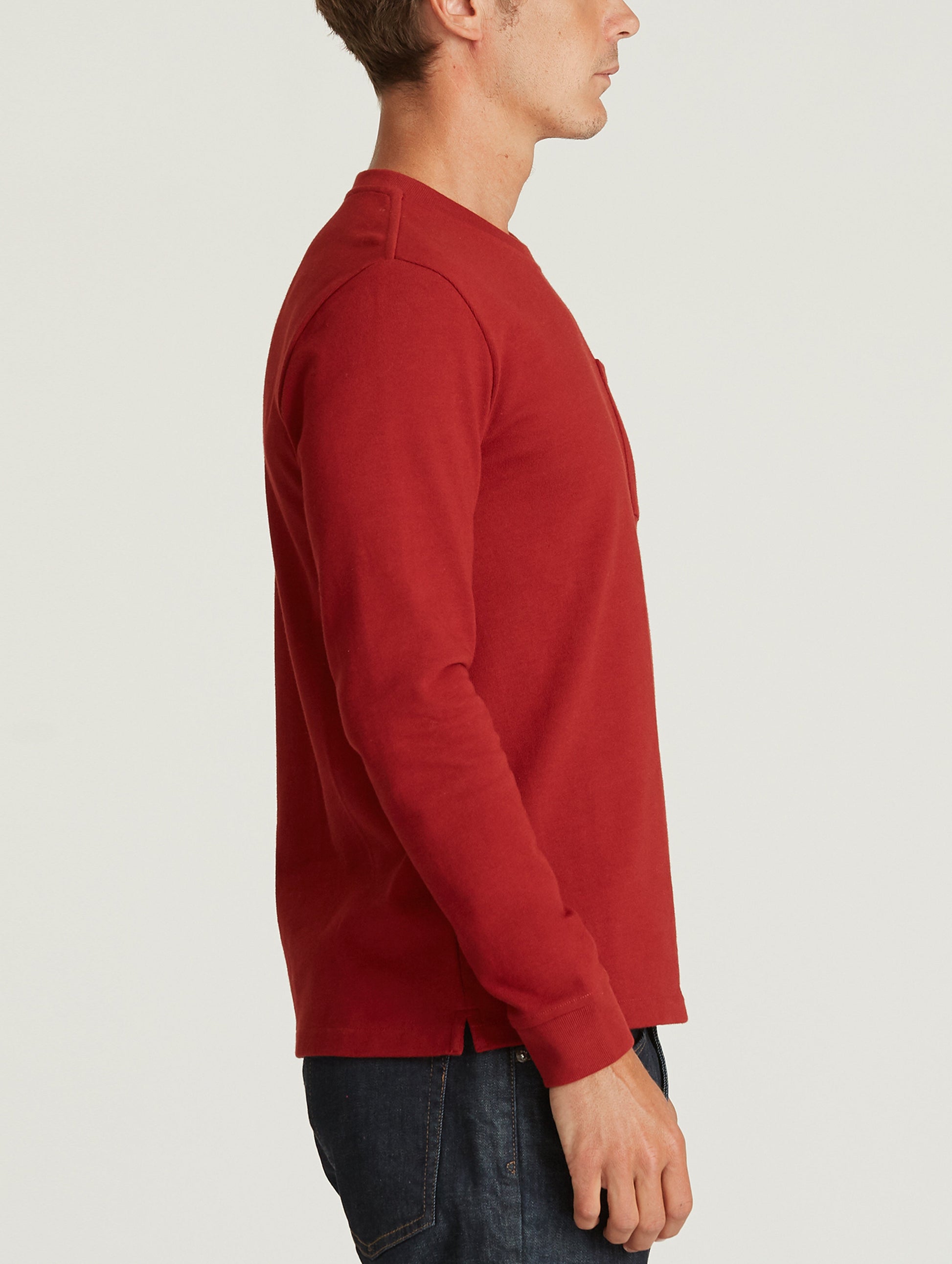 man wearing red long sleeve shirt with pocket