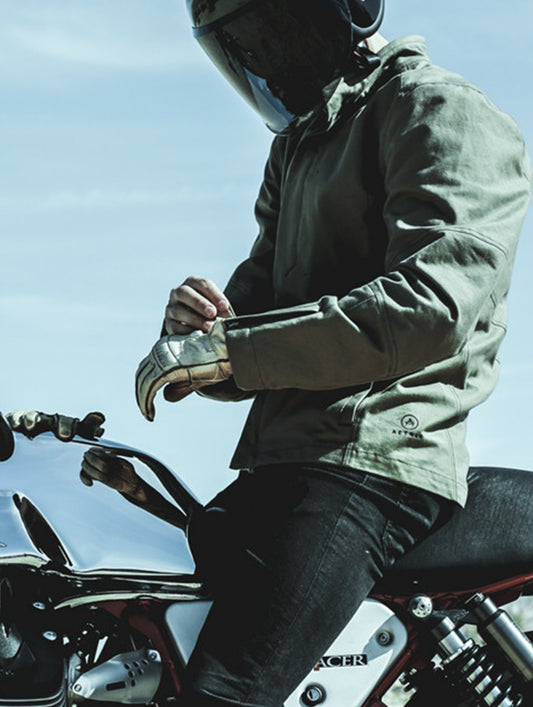 Man on motorcycle outdoors wearing light brown Loop Motorcycle Jacket from AETHER Apparel.