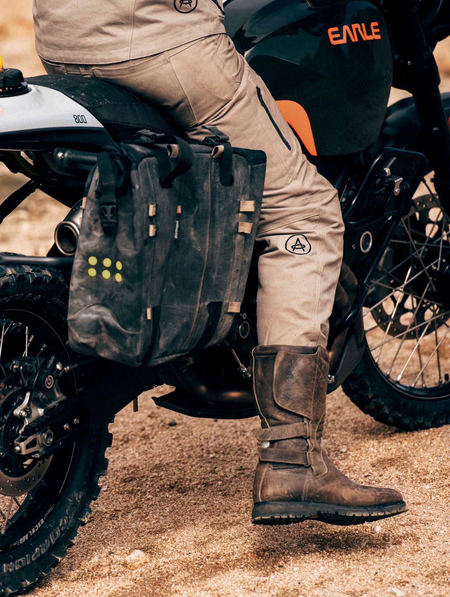 man wearing tan pants sitting on motorcycle