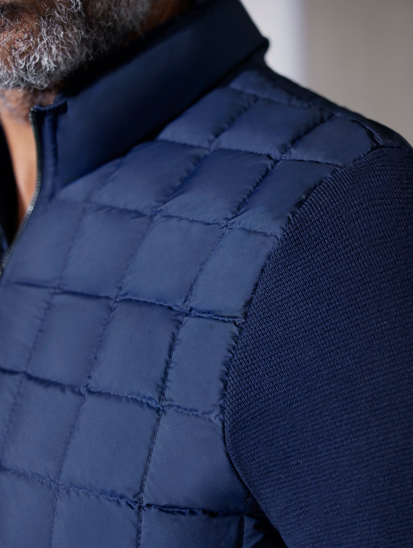 man wearing quilted blue full-zip sweater