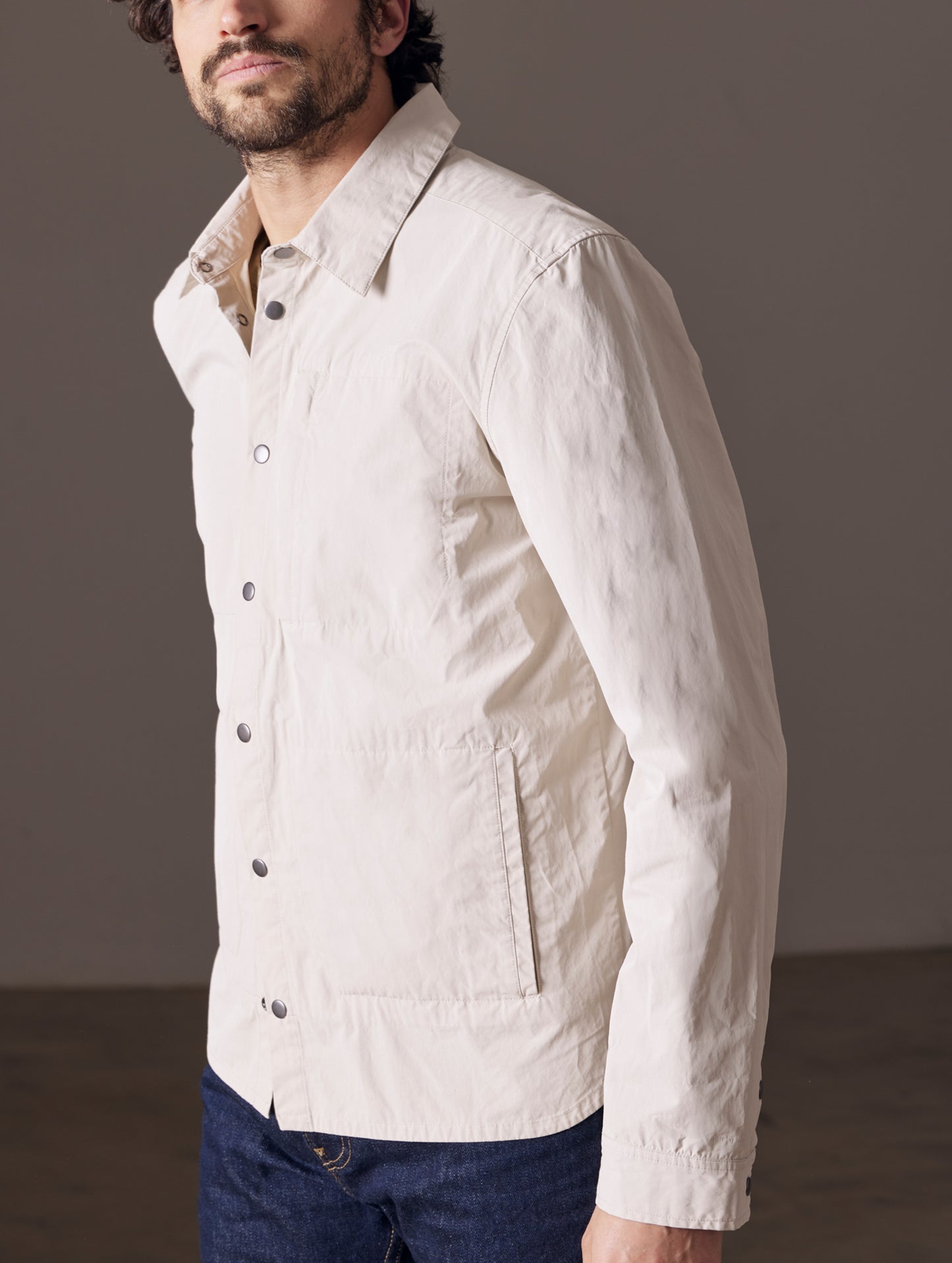 Front 3/4 body view of man wearing Pine Shacket in Bone white from AETHER Apparel.
