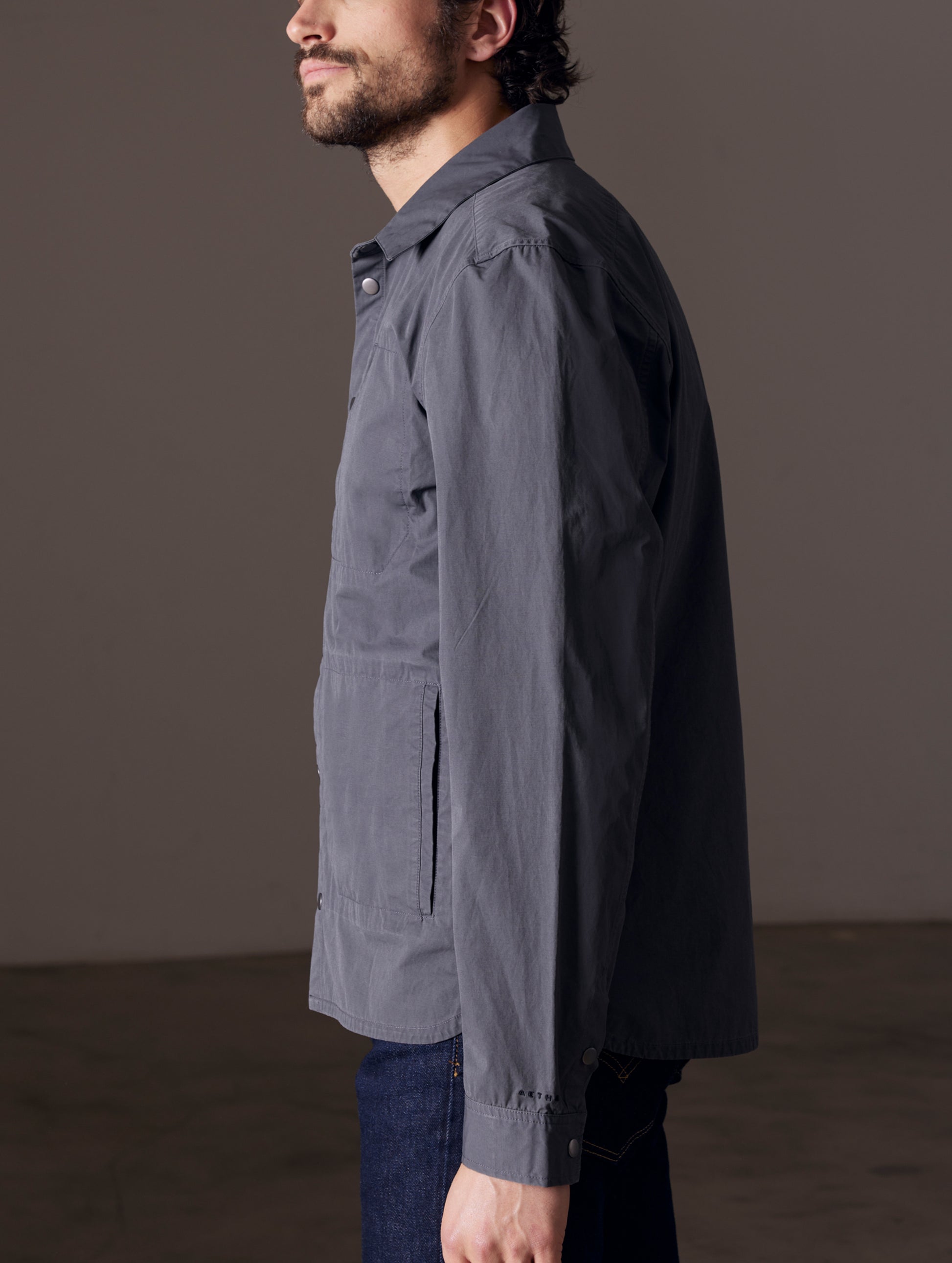 Side view of man wearing grey shirt jacket