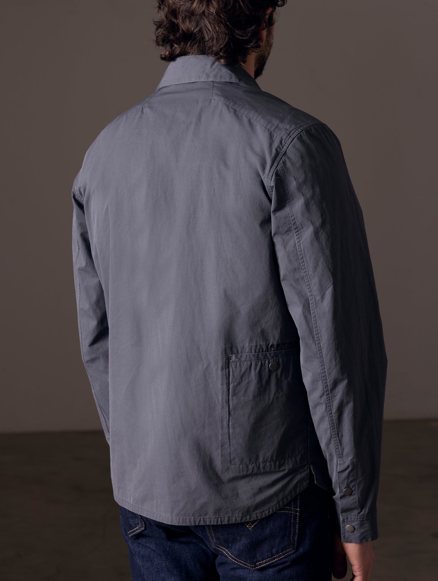 Back view of man wearing grey shirt jacket