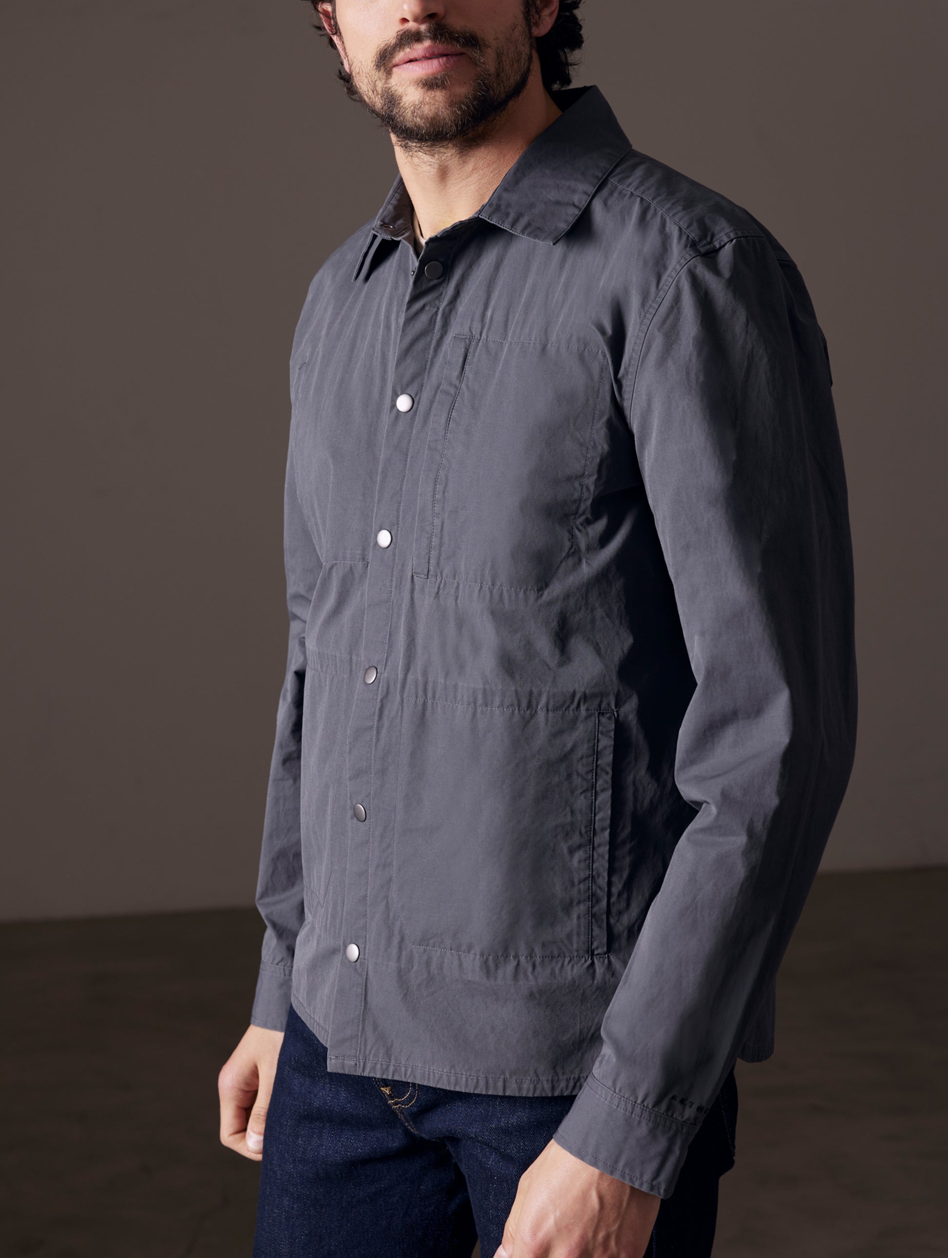 Front 3/4 body view of man wearing Pine Shacket in Graphite from AETHER Apparel.