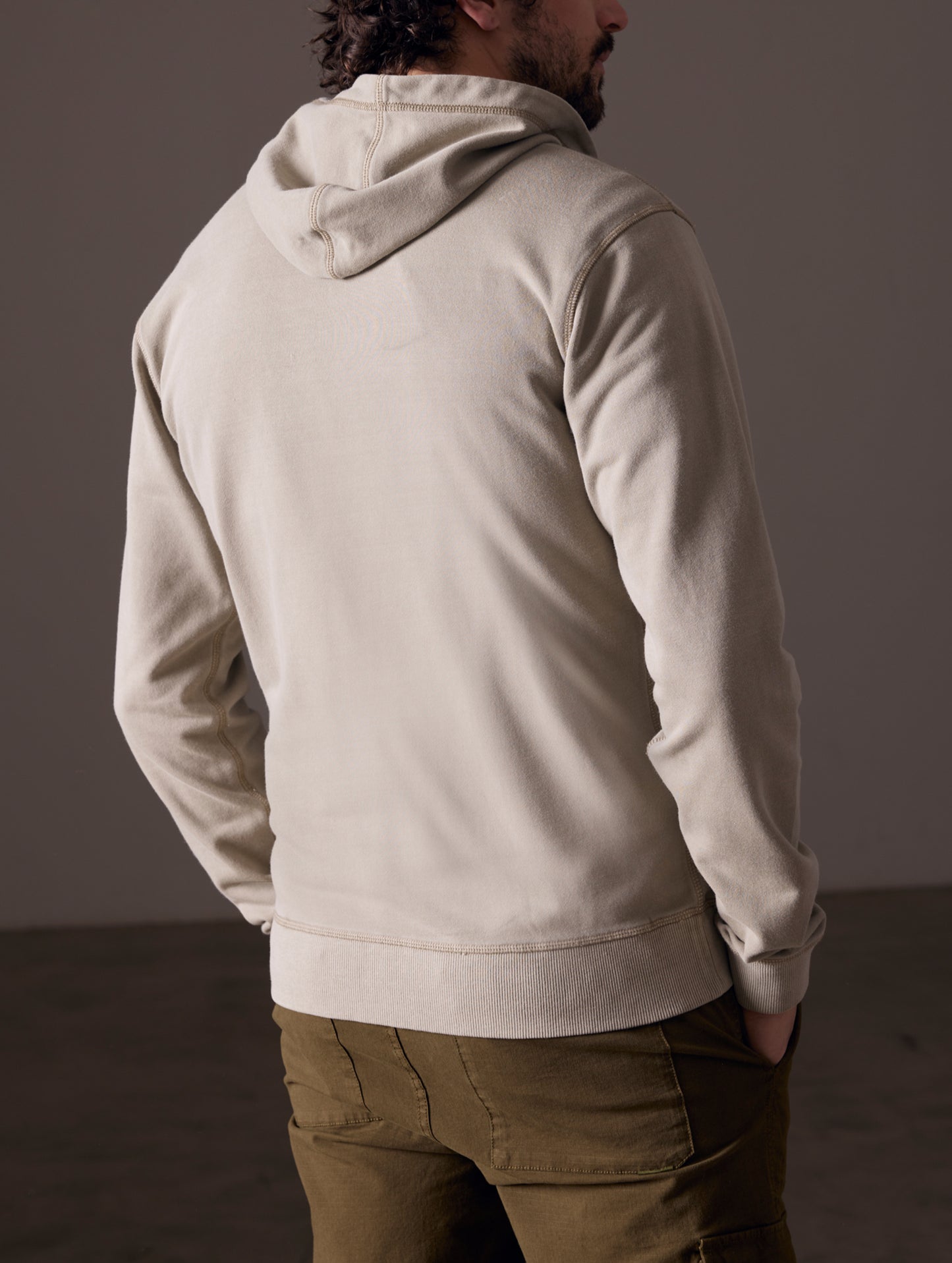 Back view of man wearing full-zip hoodie