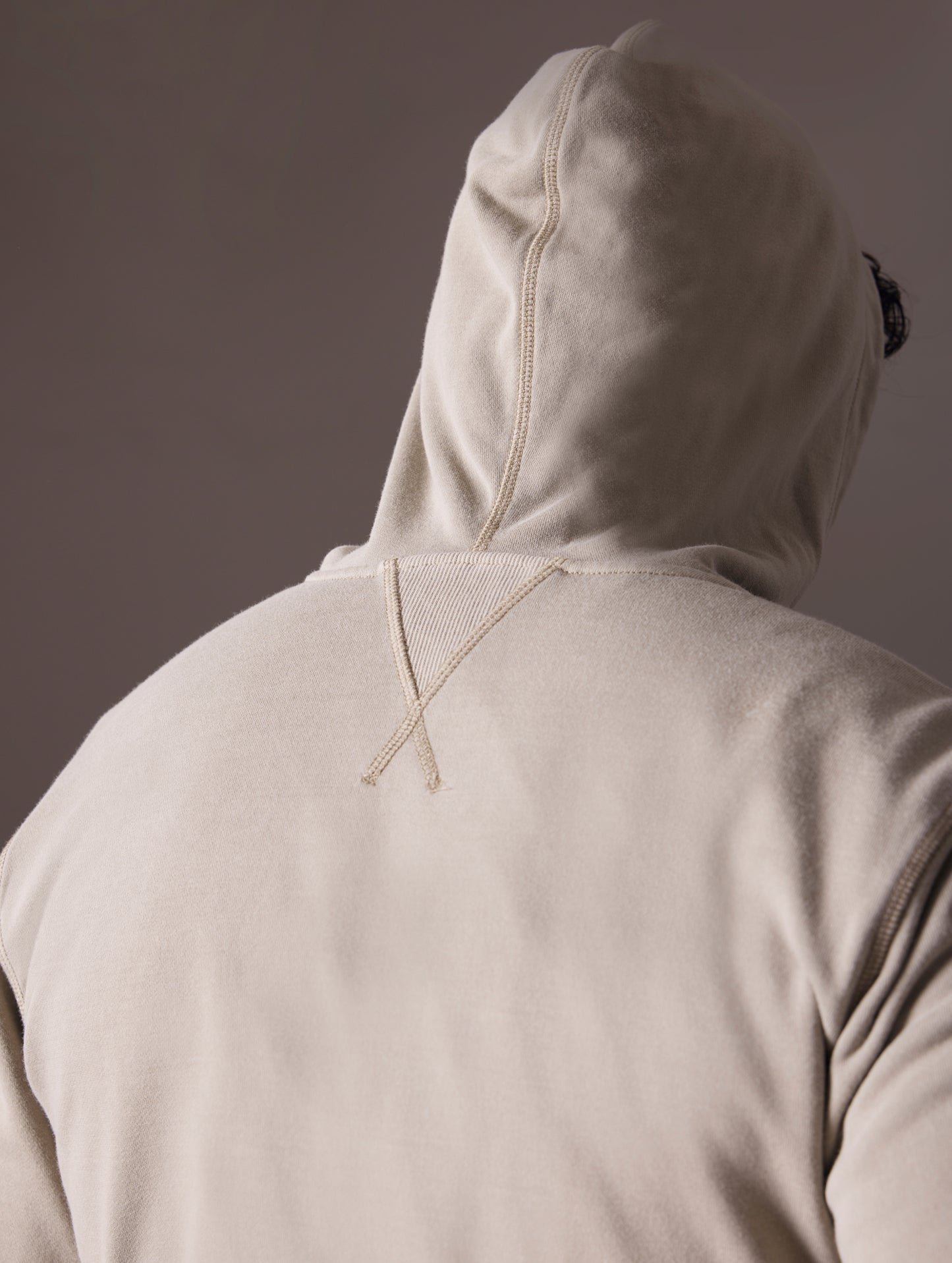 Back view of man wearing grey full-zip hoodie from AETHER Apparel