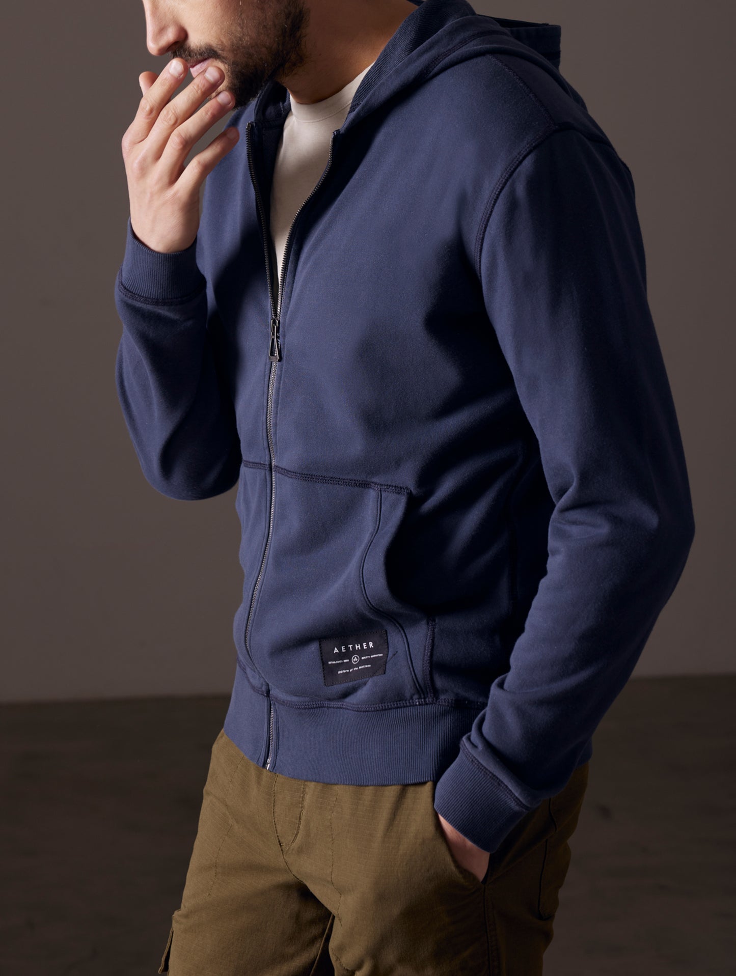 Man wearing blue full-zip hoodie from AETHER Apparel