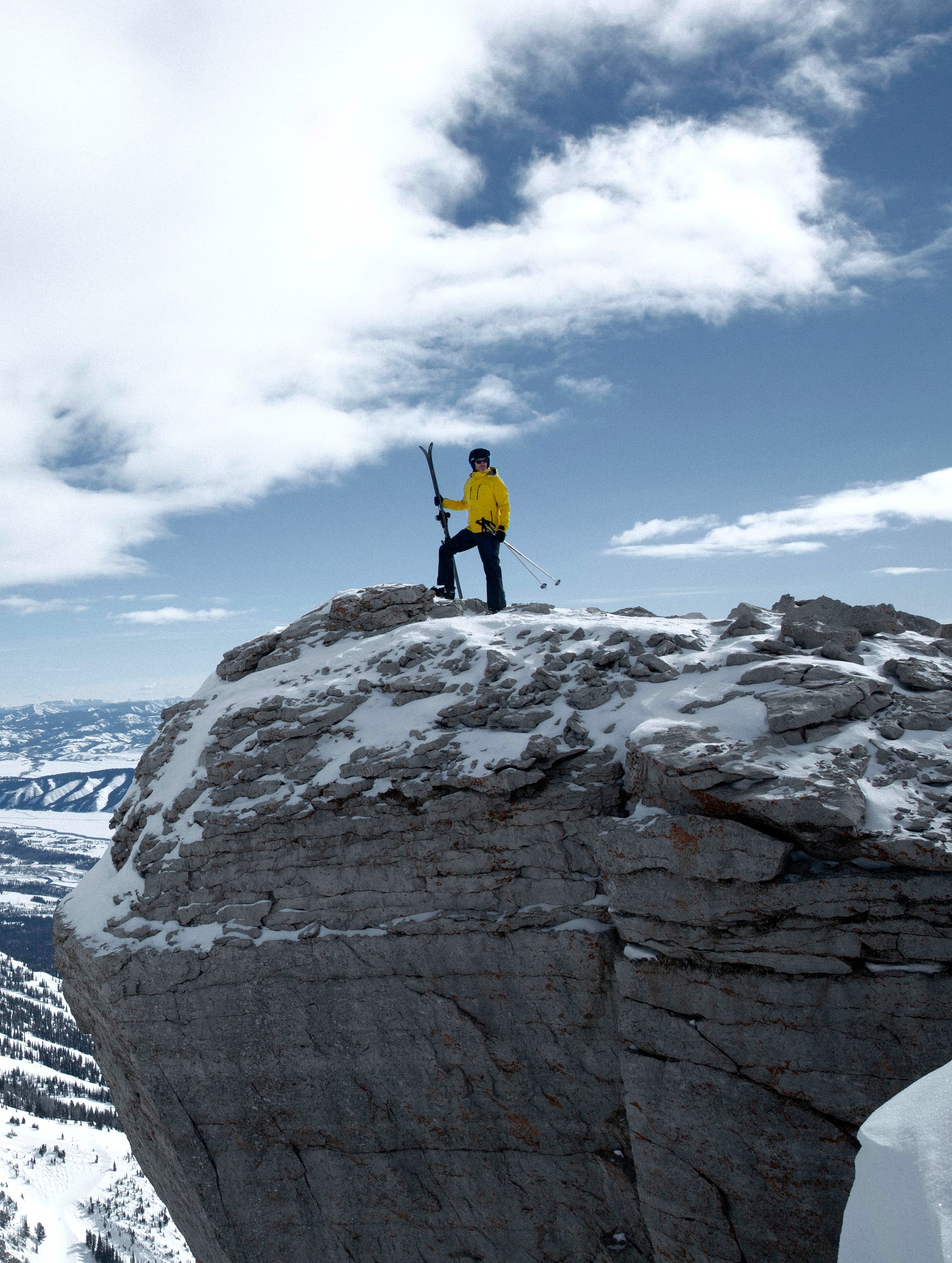 man wearing yellow snow jacket on mountain
