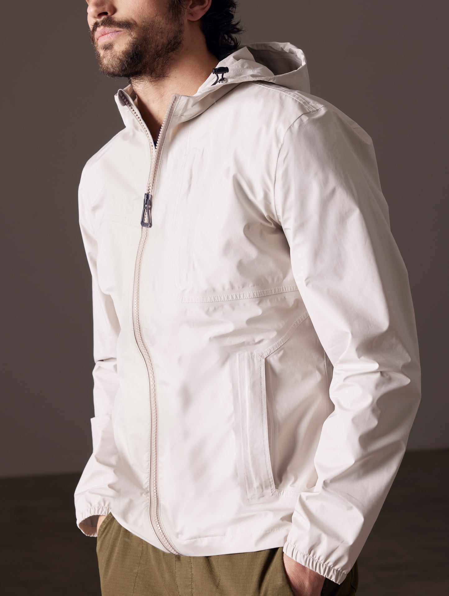 man wearing beige waterproof jacket