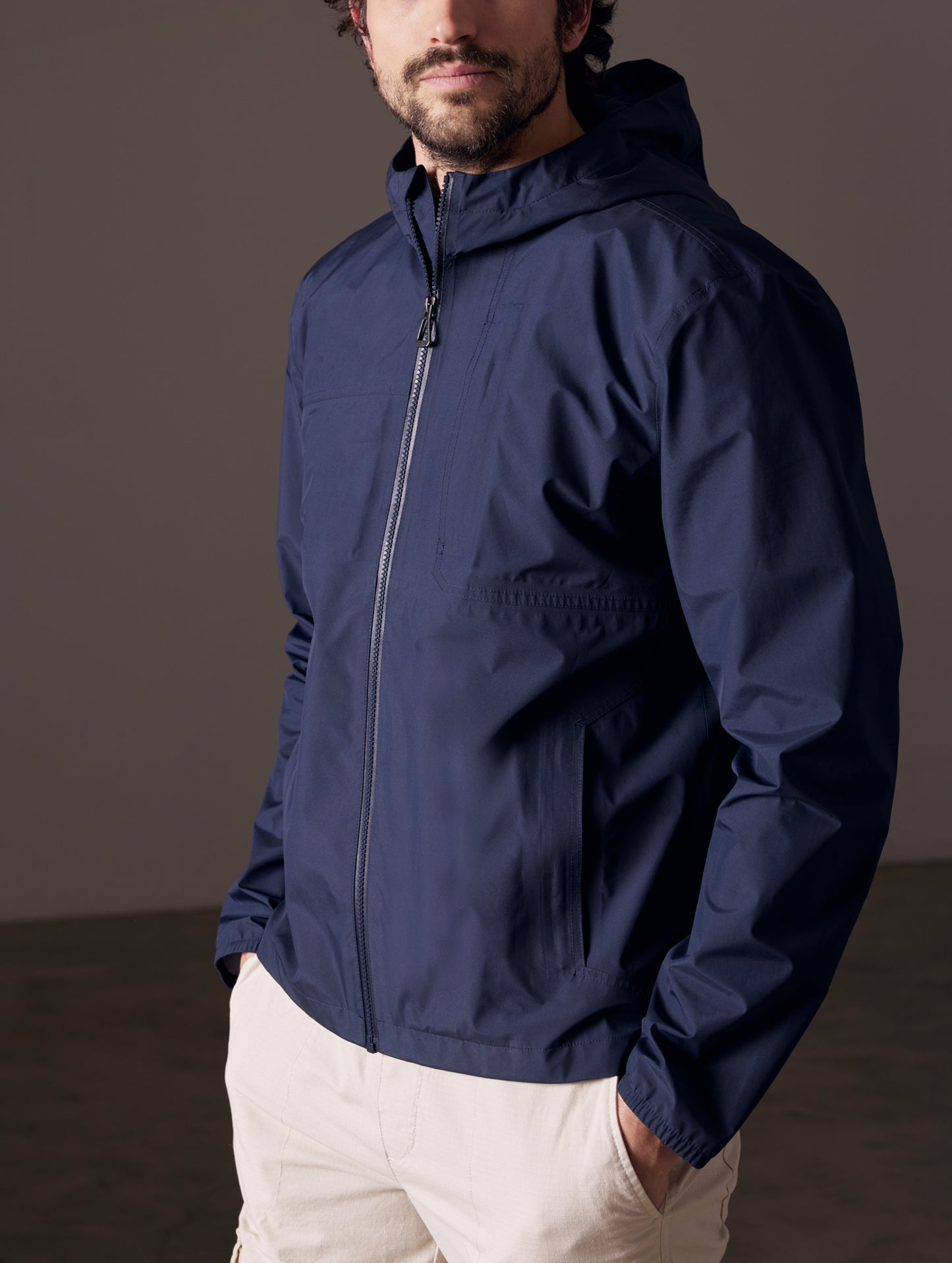 man wearing blue waterproof jacket