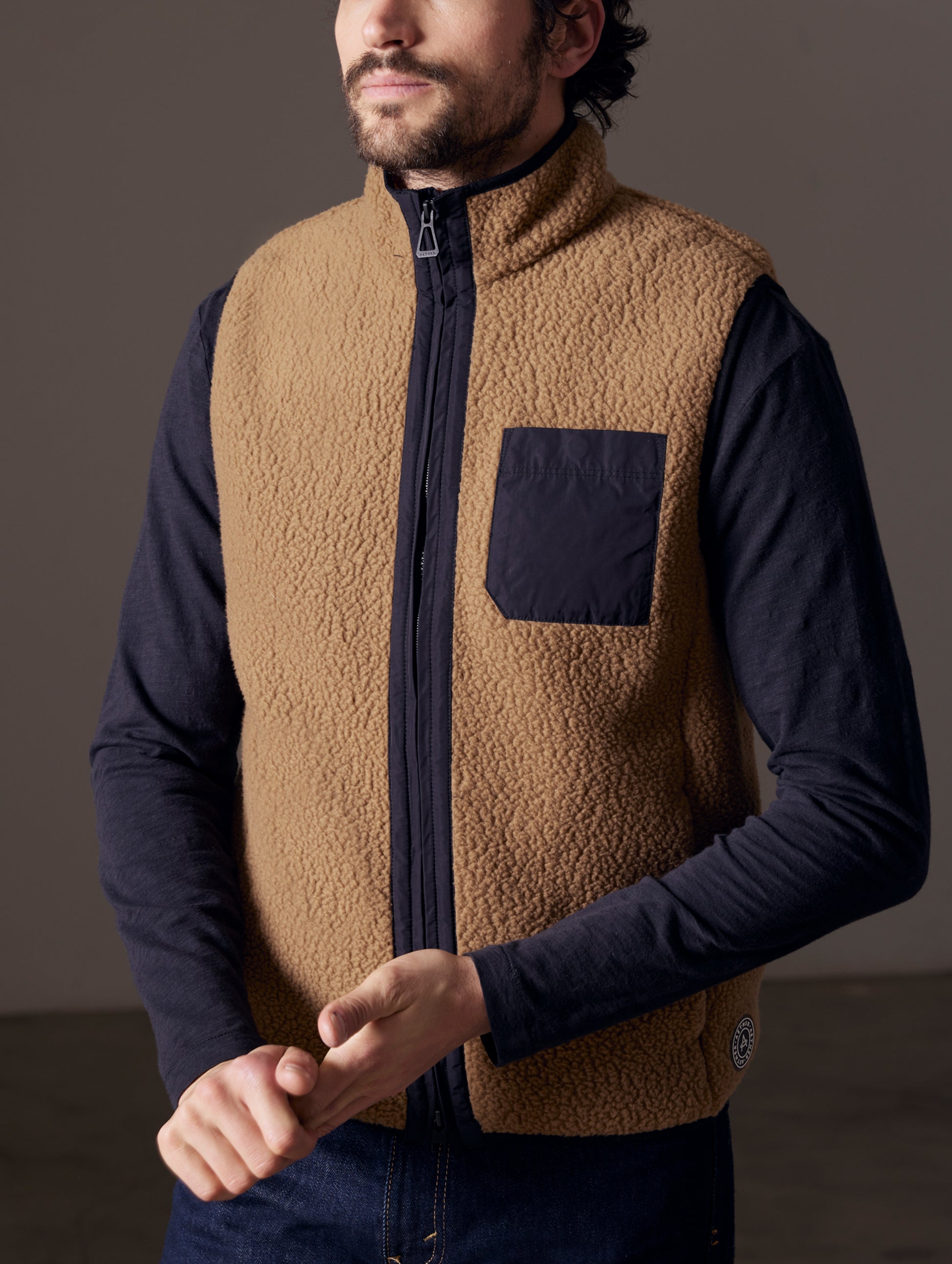 man wearing brown fleece vest