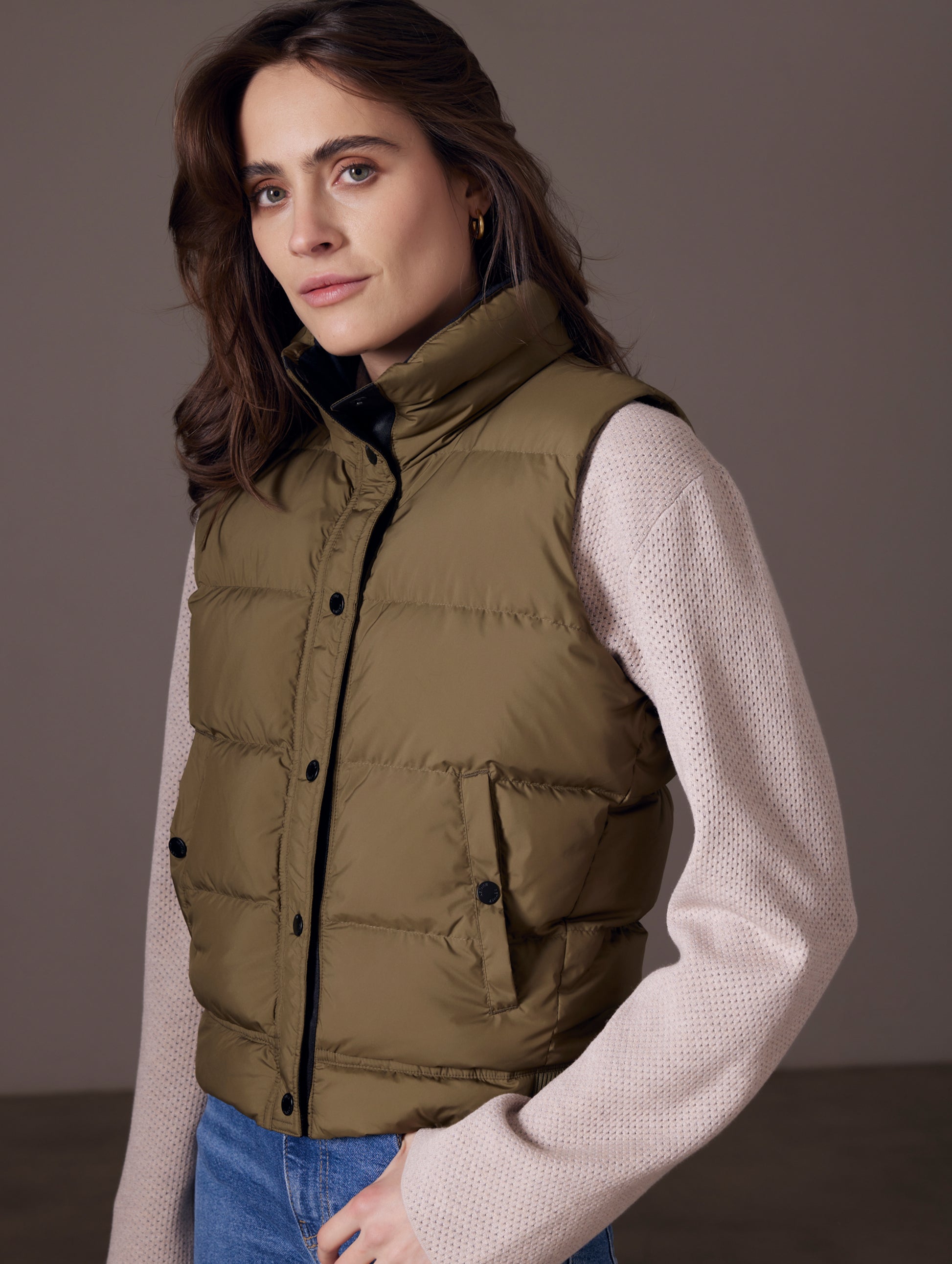 woman wearing green insulated vest from AETHER Apparel