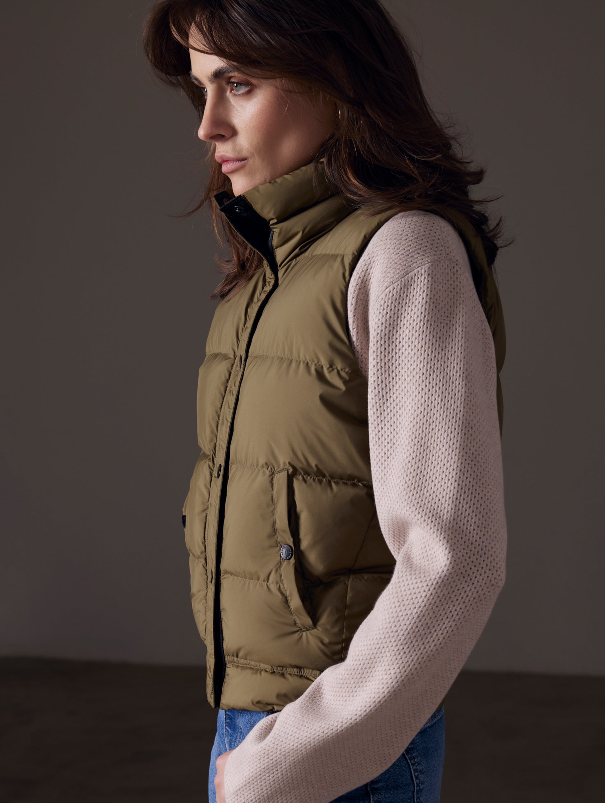 woman wearing green insulated vest from AETHER Apparel