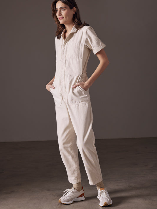 woman wearing beige short-sleeve jumpsuit from AETHER Apparel