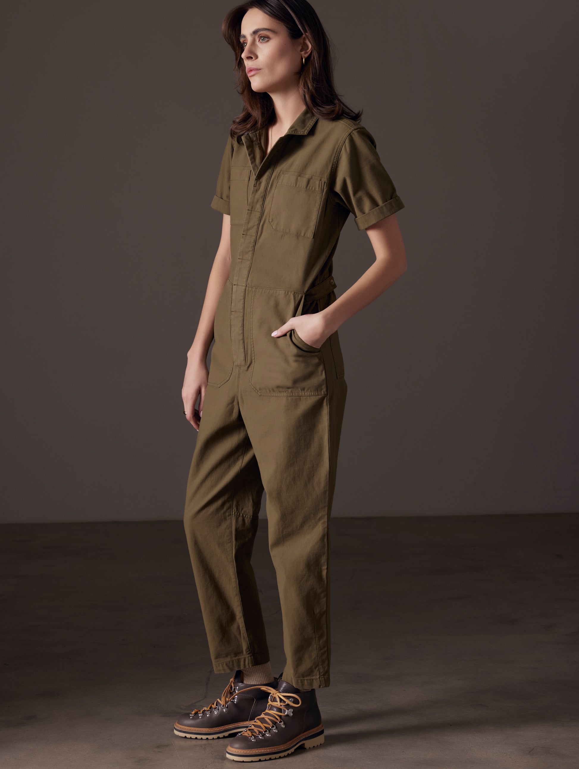 woman wearing green short-sleeve jumpsuit from AETHER Apparel