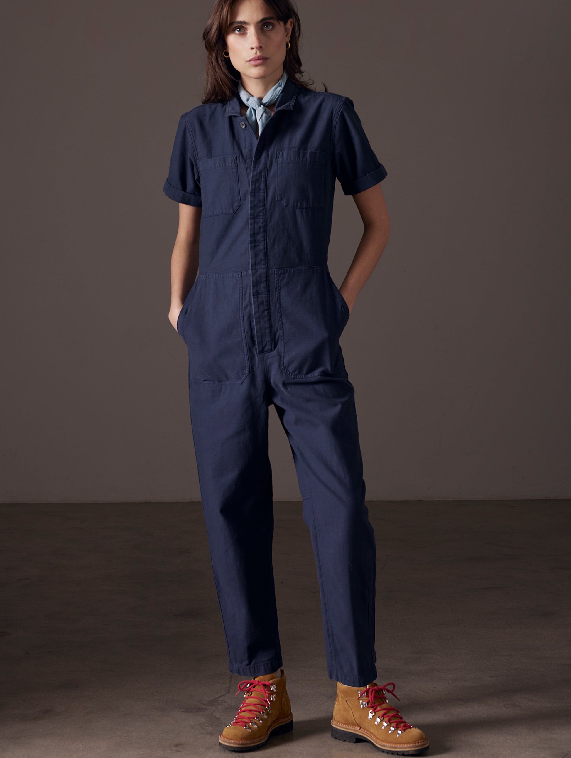 woman wearing blue short-sleeve jumpsuit from AETHER Apparel