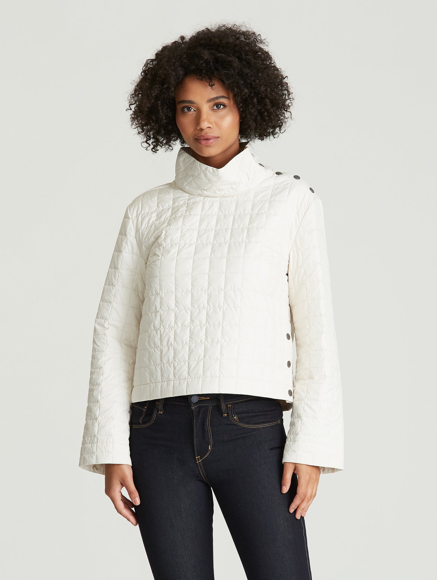 woman wearing quilted beige pullover