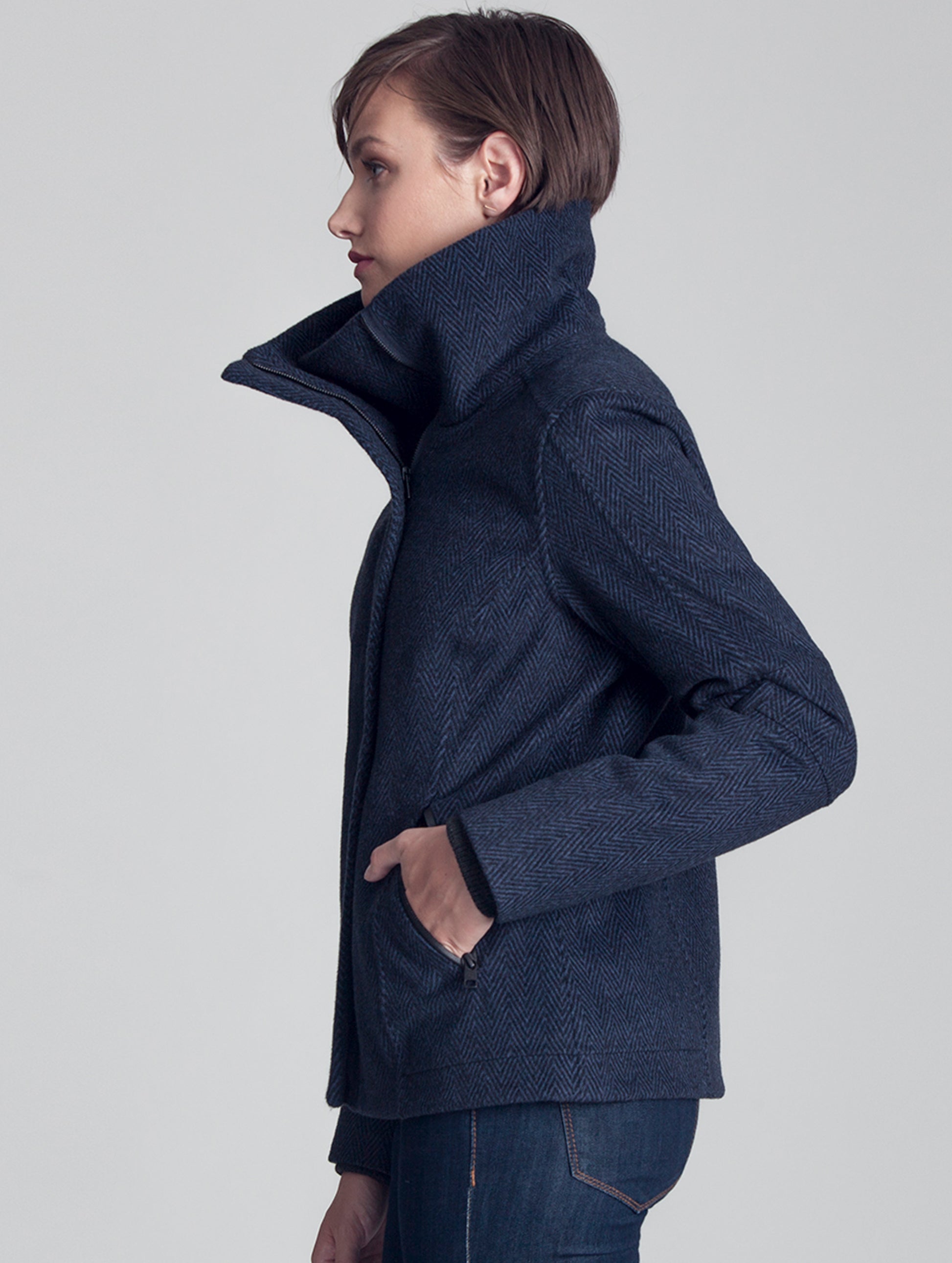Side view of woman wearing blue Crosby Jacket from AETHER Apparel.