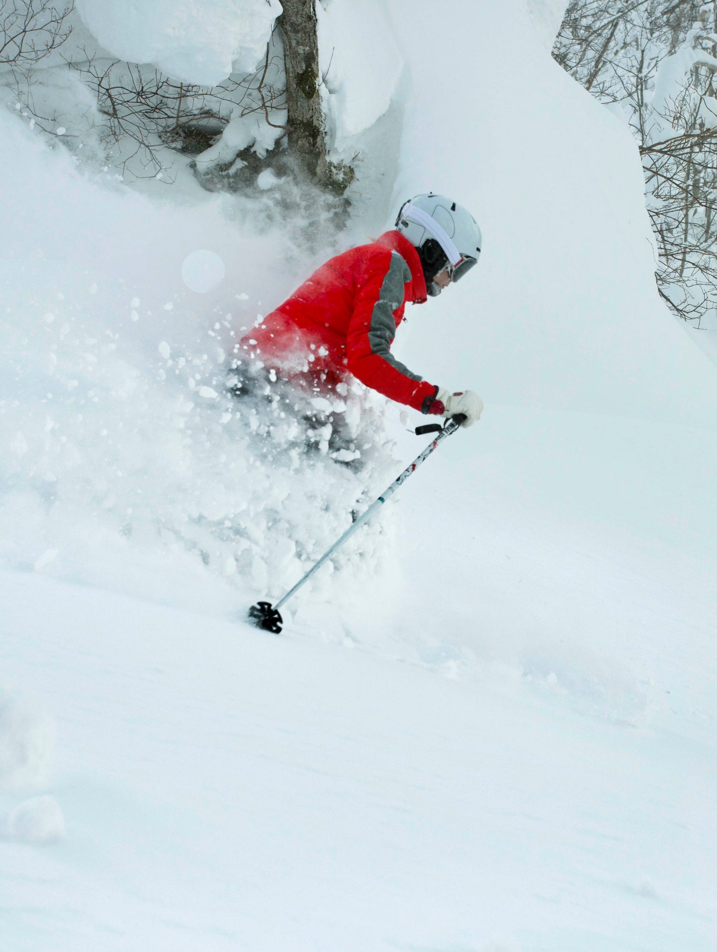 Woman skiing in deep powder snow in Hokkaido, Japan