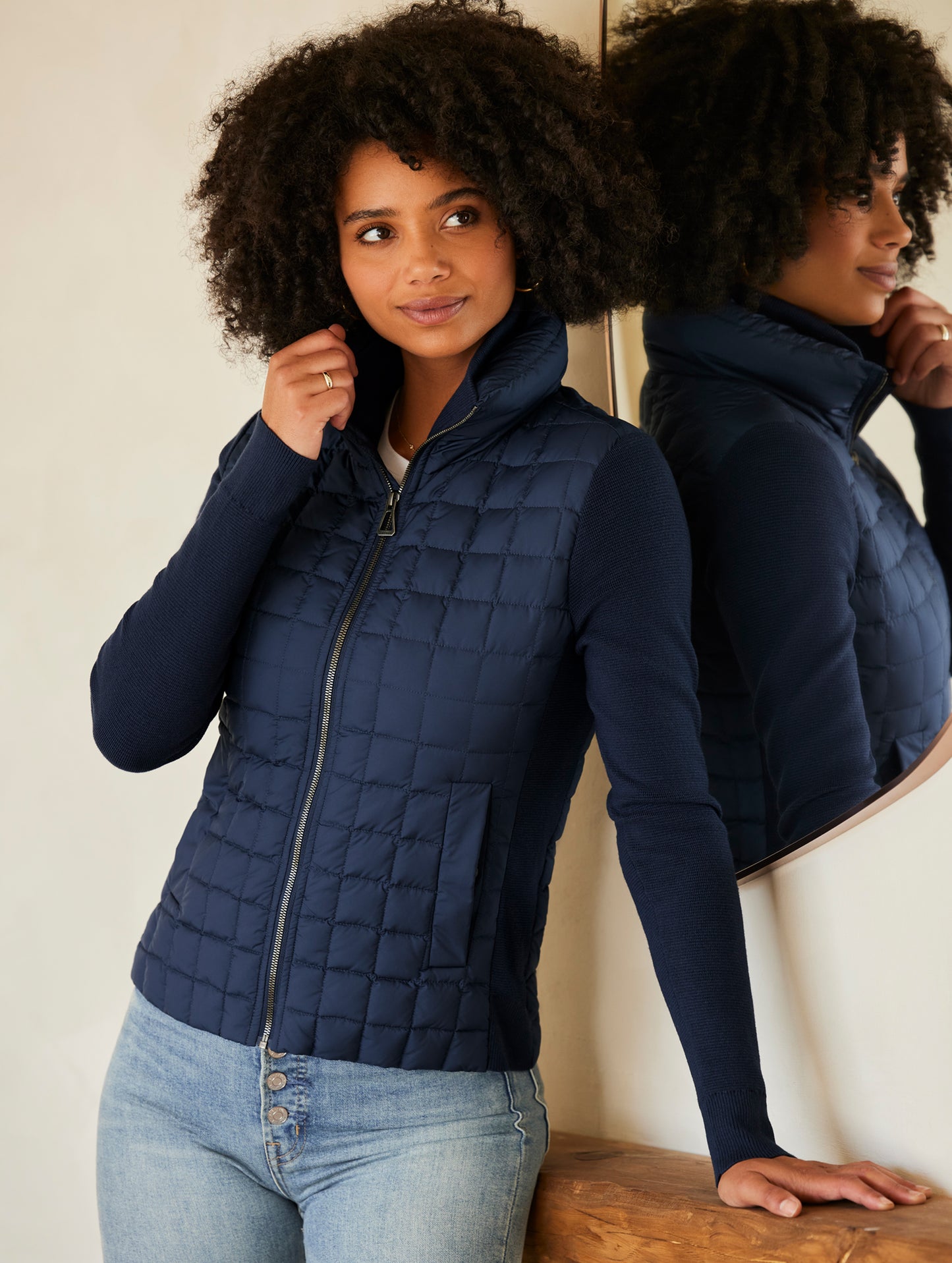 woman wearing quilted blue full-zip sweater