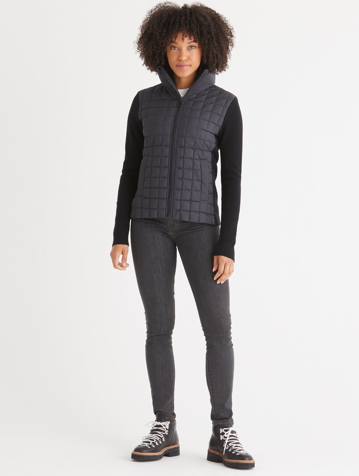 woman wearing quilted black full-zip sweater
