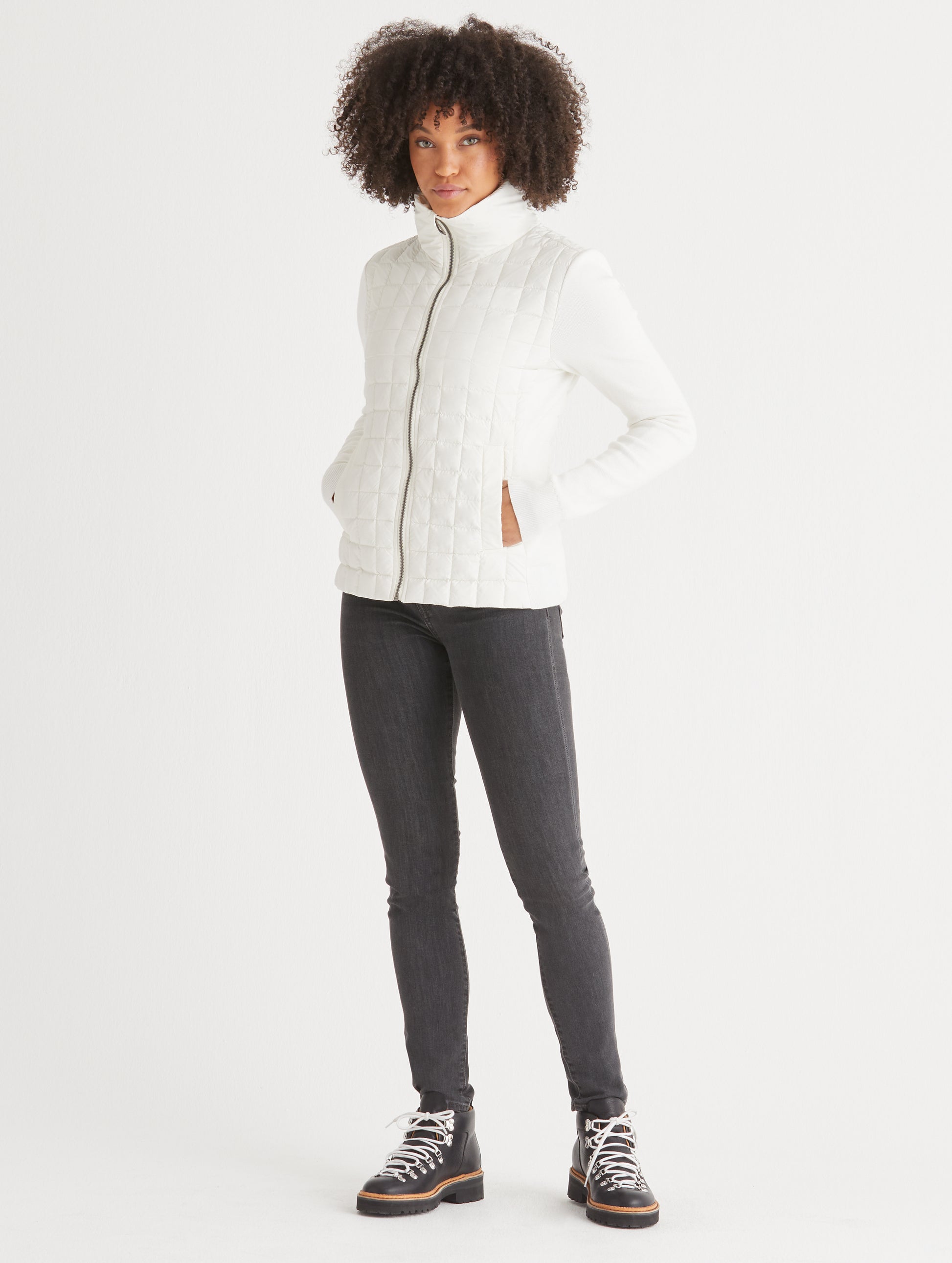woman wearing quilted white full-zip sweater