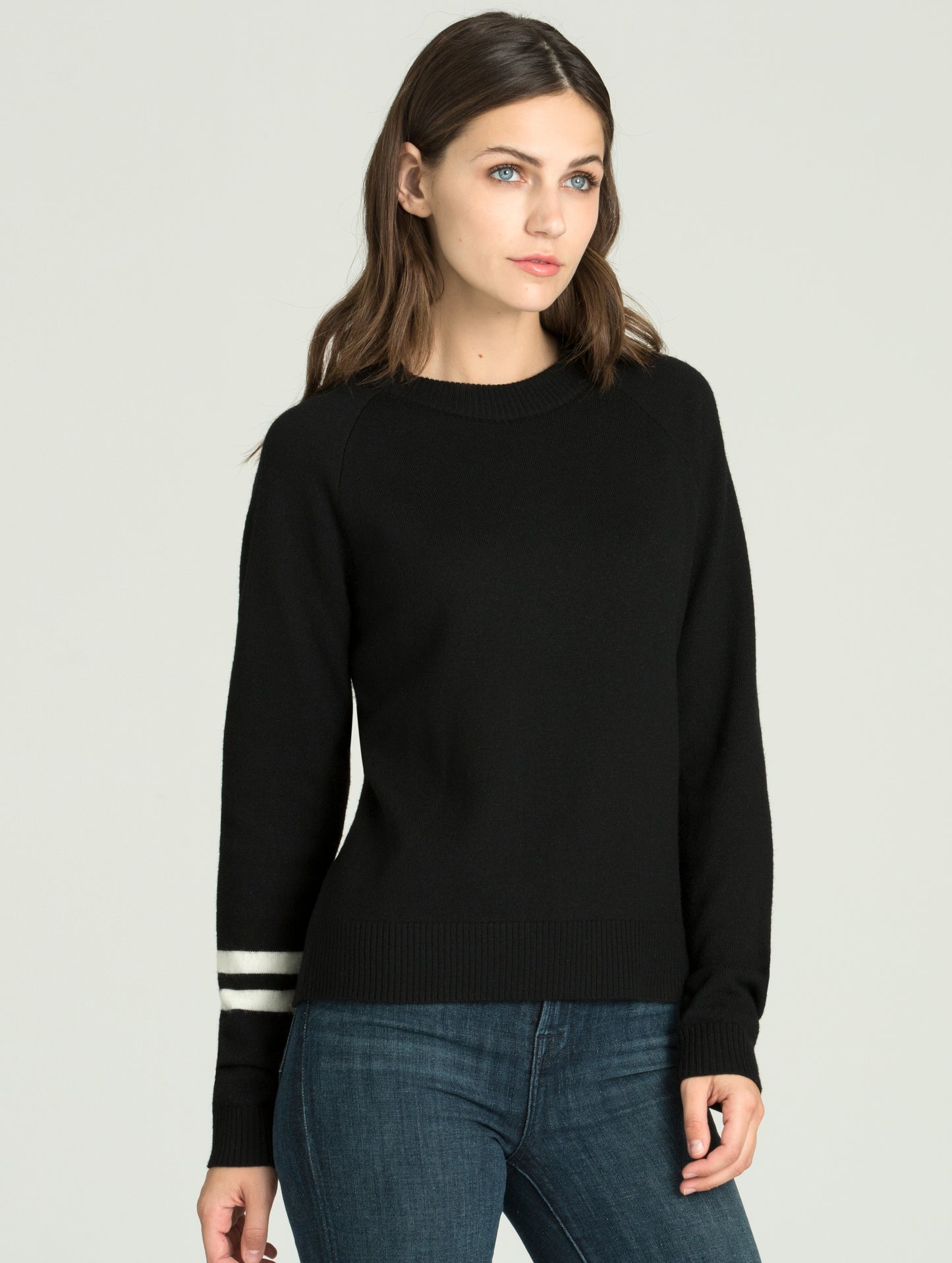 Front angled view of woman wearing Racer Sweater in Onyx Black from AETHER Apparel.