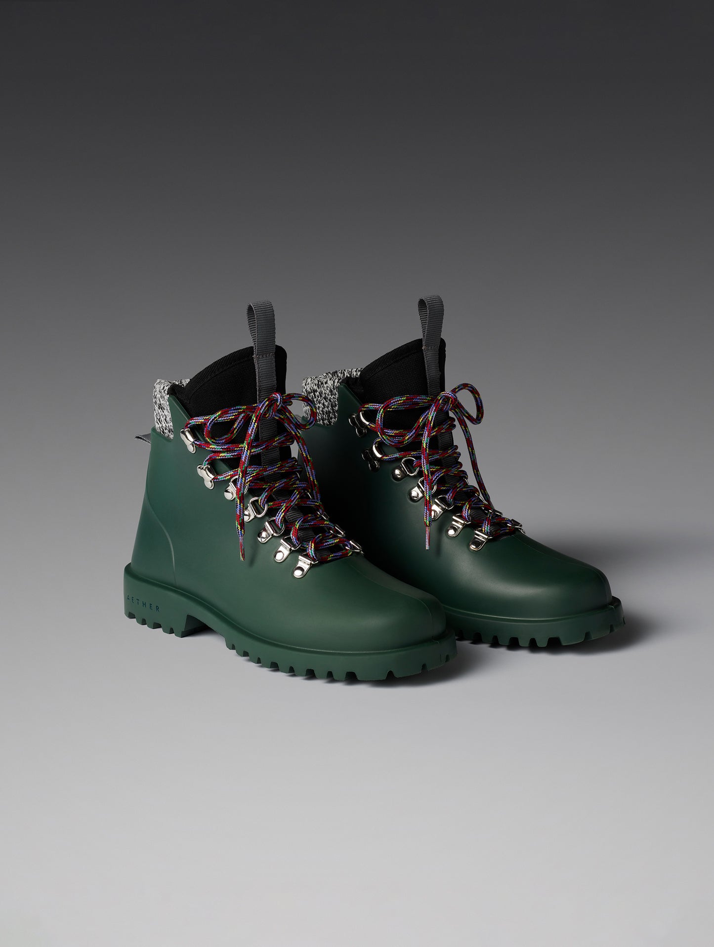Front angled view of women's Rain Boot in Dark Green from AETHER Apparel with alternative laces. 