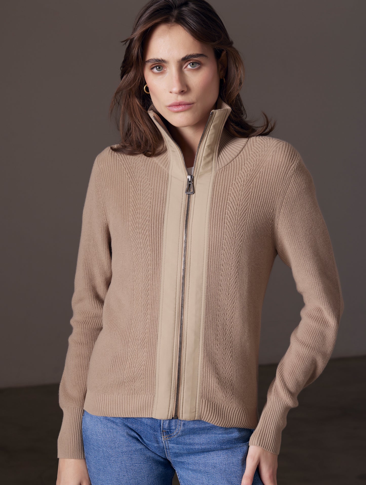 Woman wearing brown full-zip sweater