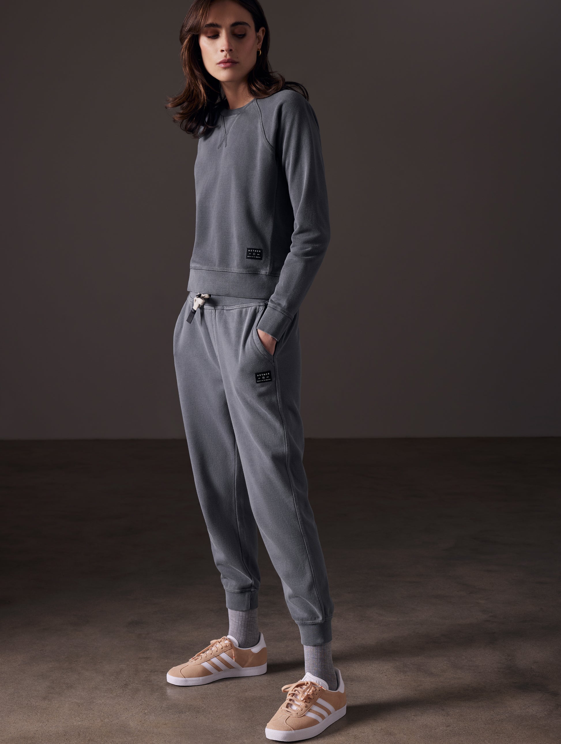 Front angled full-body view of woman wearing Solstice Lightweight Jogger in Graphite from AETHER Apparel.