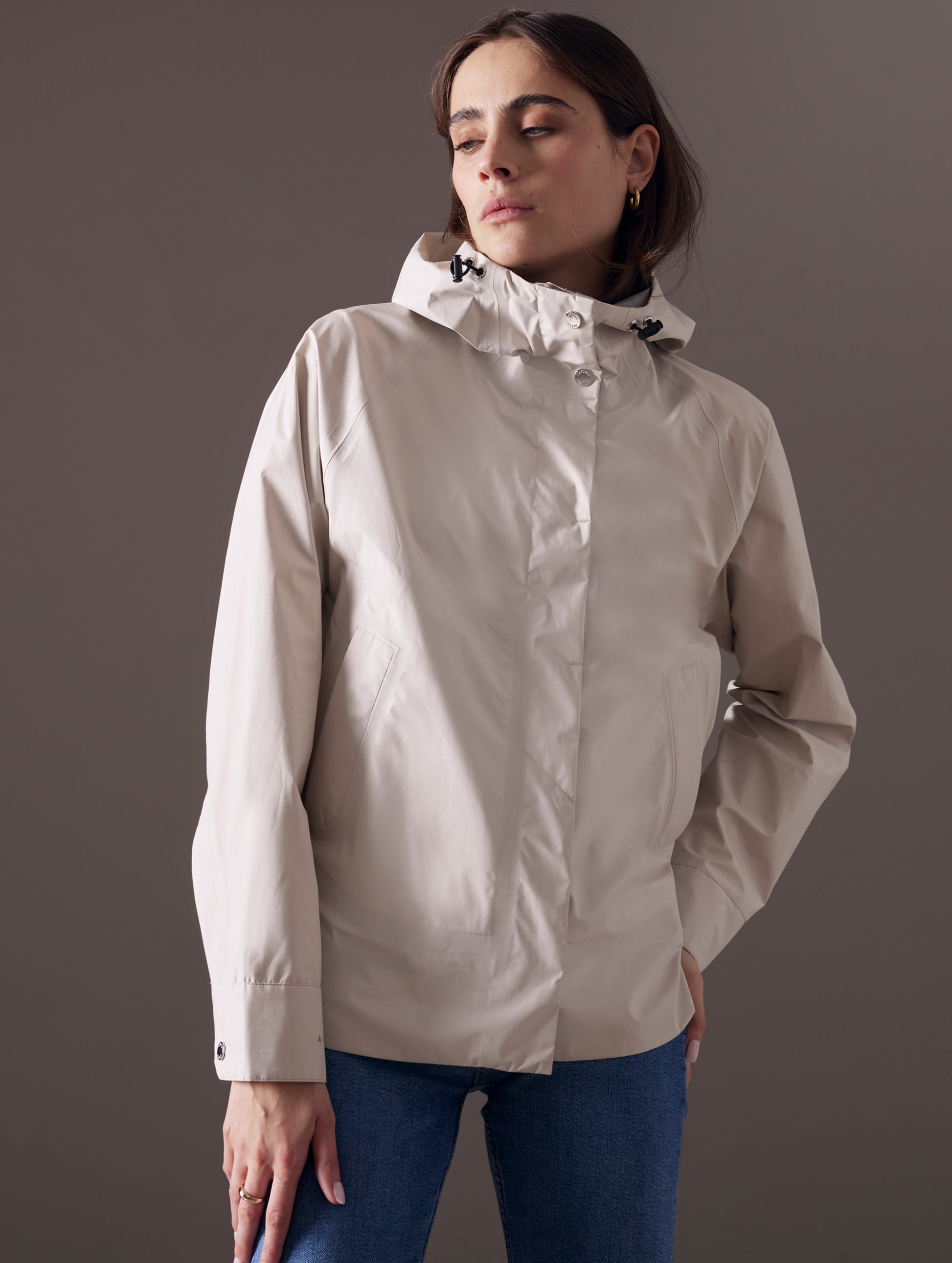 woman wearing beige waterproof jacket