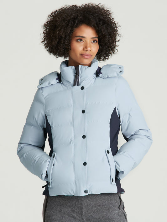 woman wearing light blue ski jacket from Aether Apparel