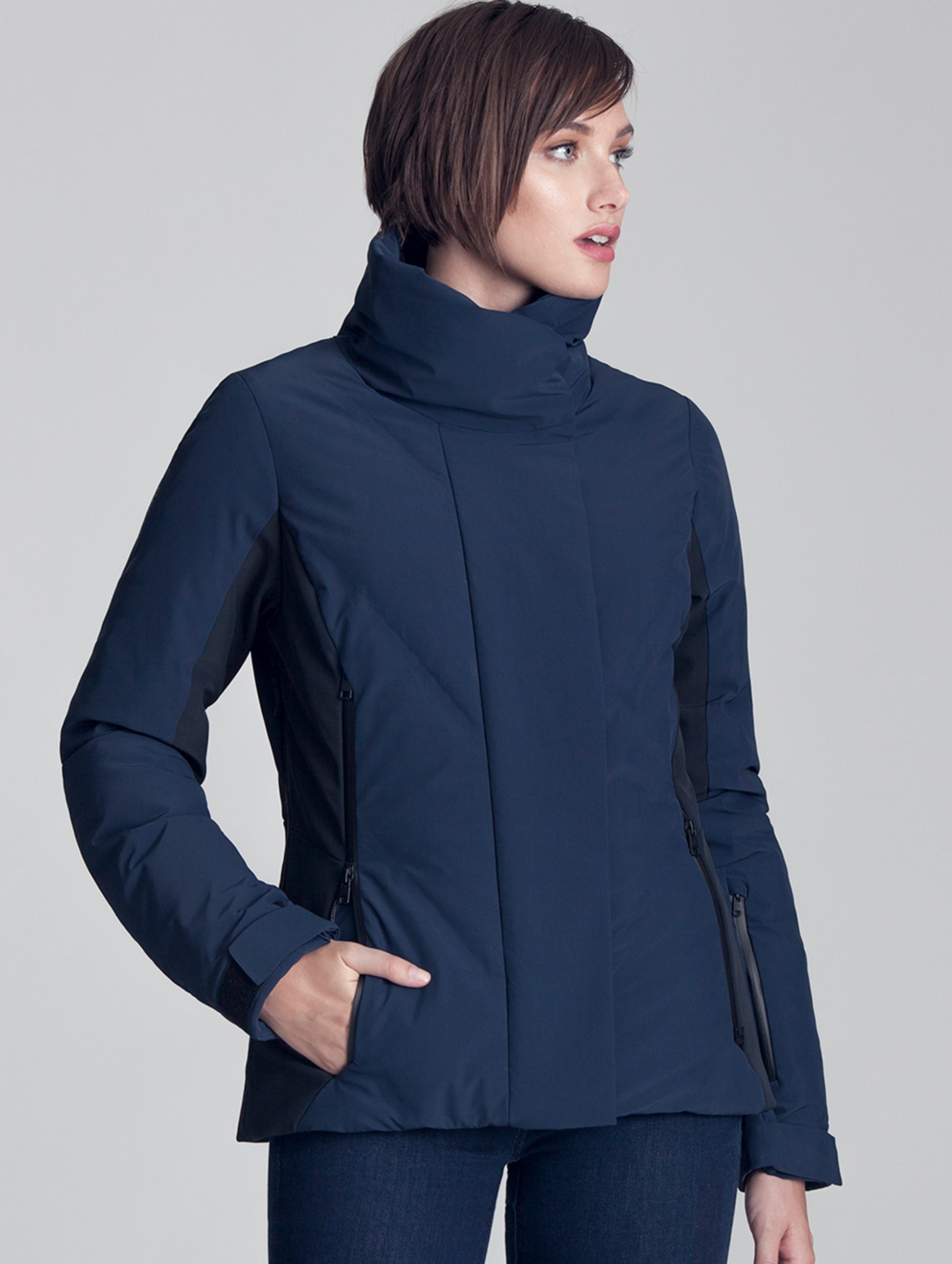 Upper body view of woman wearing blue Vertical Jacket from AETHER Apparel